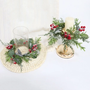 Detail of Christmas mini wreath with snowy red berries and eucalyptus on a candle holder