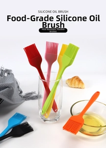 Set of colorful silicone basting brushes in a glass jar for baking and BBQ use