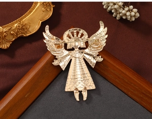 Detail view of the vintage angel brooch back with secure pin on a rustic background