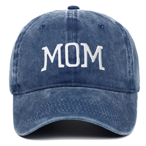 Detail of MOM embroidery on washed navy blue denim cotton vintage baseball cap