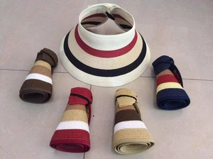 Foldable wide brim straw sun visor showing rolled up storage with elastic band