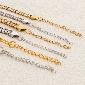Detailed macro shot of 18K gold and silver stainless steel jewelry chains with rhinestones