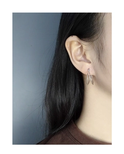 Close-up of minimalist S925 sterling silver double hoop earrings worn on an ear