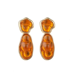 Detail of 14k gold-plated brass earrings with amber gemstones and sparkling zircons