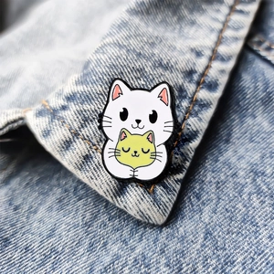Cute enamel magic cat metal pin badge on a denim jacket collar for school backpack