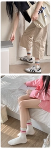 Detail of striped cotton socks with smile embroidery shown in a lifestyle indoor setting