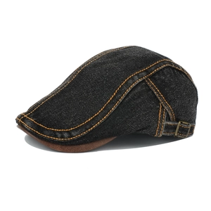 Detail view of denim ivy cap with orange stitching and metal side adjustment buckle