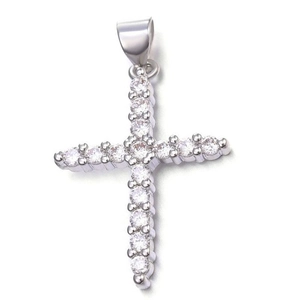 Detailed macro view of silver cross pendant with sparkling white cubic zirconia stones