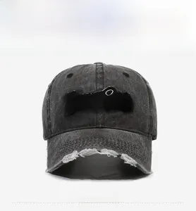 Detail of distressed brim and Purist embroidery on dark grey washed denim baseball cap