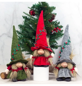 Detail of Christmas gnomes featuring textured hats with leaf and berry embellishments