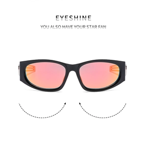 Detail of Y2K futuristic sunglasses with orange-pink lenses and silver metal side accents