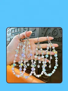 Close-up of beaded heart keychains with pearls and iridescent crystal beads