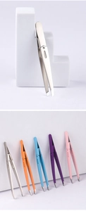 Detail of colorful foldable stainless steel eyebrow tweezers set on white steps