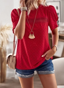 Detailed close-up of red hollow-out embroidery and trendy puff sleeves on a casual top