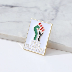 Detail of Free Palestine flag pin badge with enamel finish on marble surface