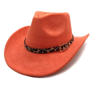 Detailed close-up of orange faux suede cowboy hat with leopard print belt and golden buckle