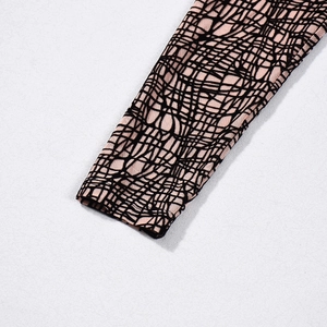 Detail shot of long sleeve cuff with pink and black geometric mesh print design