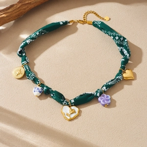 Bohemian choker necklace featuring multi-layered heart pendants and floral fabric cord