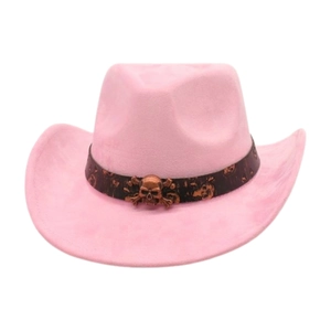 Pink suede cowboy hat with vintage bronze skull accessory on white background