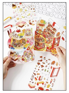Macro view of hands holding 2.5D creative dessert shop and burger shop stickers