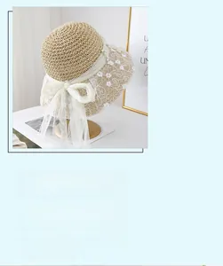 Detailed view of women's crochet straw hat with floral lace, pearls and UPF 50+ wide brim