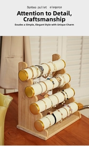 Close-up of a five-tier bamboo jewelry display stand with white velvet rollers and gold caps