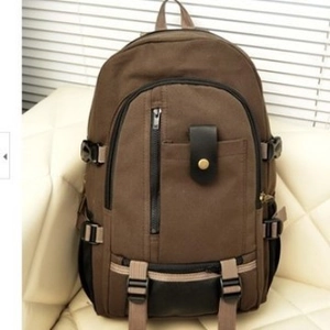 Vintage dark brown canvas backpack with leather straps and functional metal buckles