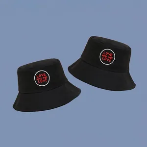 Classic black cotton bucket hat featuring LOVE MAKES MORE LOVE embroidery on blue background