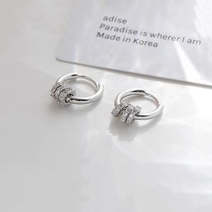 Detail of silver drop earrings with three dangling micro-pave zircon stone rings