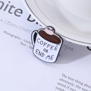 Detailed close-up of a coffee cup enamel pin with COFFEE OR END ME text on magazine