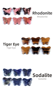 Macro detail showing hand-carved rhodonite, tiger eye, and sodalite stone butterflies