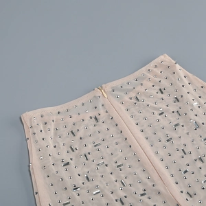 Detailed view of sheer mesh fabric with silver rhinestones and invisible zipper