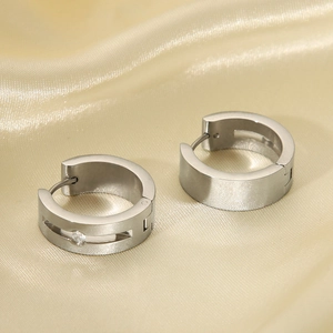 Silver titanium steel hoop earrings with crystal stone on elegant champagne silk fabric