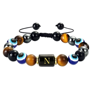 Adjustable tiger eye and evil eye beaded bracelet featuring a gold letter N pendant