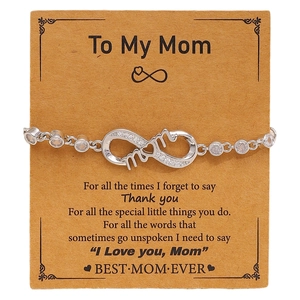 Detail of silver infinity mom bracelet with sparkling zircons on a brown gift card