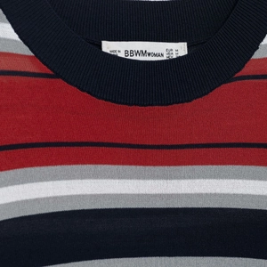 Classic striped knit top with a ribbed crew neck and branded label detail in close-up view