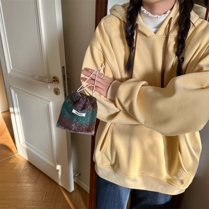 Detail of wool drawstring makeup bag with soft texture and stylish gradient design