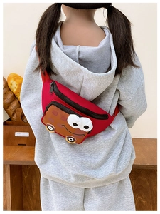 Detailed view of child wearing the red cartoon bus crossbody bag with colorful accents