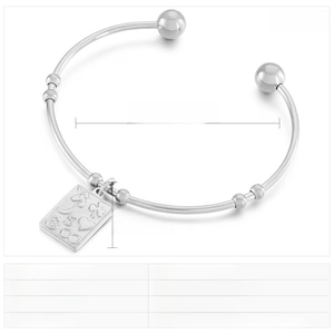 Detailed view of stainless steel bangle with engraved rectangular pendant and dimensions