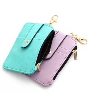 Detail view of leather card holder with card slots, zipper pocket and golden snap button