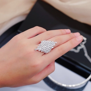 Luxe silver ring with large diamond-paved geometric face shown on a female finger