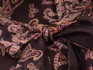 Close-up of bohemian paisley printed chiffon fabric with a decorative knot detail