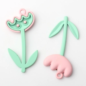 Detail of pink tulip flower and mushroom alloy pendants with mint green eyes for DIY jewelry