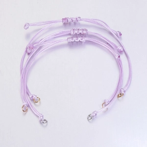 Detail view of 0.8mm light purple waxed cord bracelet with adjustable knot and metal jump rings