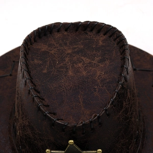 Macro detail of vintage dark brown faux leather cowboy hat with stars and stitching