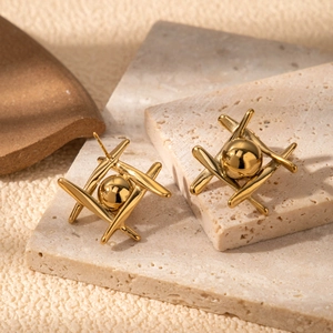Luxurious gold geometric cross stud earrings with a glossy center sphere on stone