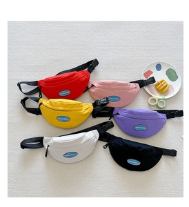Detailed view of colorful kids canvas waist bags with adjustable straps and logo