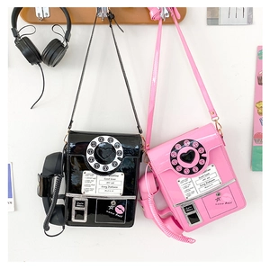 Detail view of retro phone crossbody bag with handset charm and spring cord