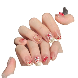 Pink lion dance press-on nails with red diamond heart patterns and festive gold glitter