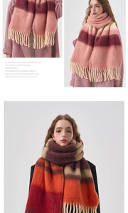 Detail of soft acrylic cashmere-like scarf showing pink and orange gradient plaid with tassels